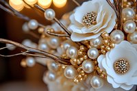 Elegant white fabric flowers with golden centers adorned by lustrous pearls and metallic copper branches create luxurious wedding or special occasion decoration.