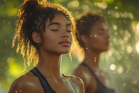 Young African American woman with curly hair meditating peacefully outdoors in golden sunlight with bokeh background for wellness and mindfulness content.