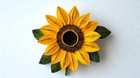 Paper art sunflower with yellow petals and brown center on white background, handcrafted quilling technique with green leaves, isolated design element.