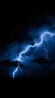 Dramatic lightning bolt striking through dark storm clouds at night, illuminating the sky with bright electric blue light and intense energy during severe weather conditions.