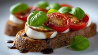 Fresh caprese bruschetta with mozzarella, cherry tomatoes and basil on rustic bread drizzled with balsamic glaze for appetizer menu design.