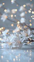 Delicate white lilies with golden stamens against soft blue background, illuminated by dreamy bokeh lights creating magical atmosphere for wedding or celebration designs.