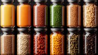 Colorful spices and legumes stored in glass jars arranged in rows, perfect for cooking, food storage and kitchen organization concepts.