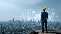 Construction engineer with yellow helmet overlooking cityscape with digital overlay of architectural plans and data visualization for urban development.