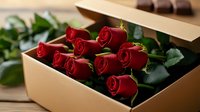 Fresh red roses arranged in elegant gift box with green leaves, romantic floral arrangement for Valentine's Day, anniversary, or special occasion celebration.