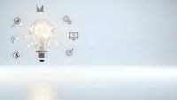 Glowing light bulb with business icons on clean white background representing innovation, creativity and strategic planning concepts for corporate presentations.