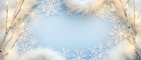 Winter holiday background with white snowflakes, birch branches, feathers and warm lights on soft blue surface for seasonal greeting cards.