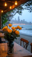 Yellow roses in mason jar on waterfront restaurant table at dusk, with city skyline and string lights creating romantic ambiance. Moody evening atmosphere.