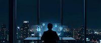 Businessman silhouette viewing digital security interface with lock icons and shield symbols against city skyline at night for cybersecurity concepts.