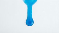 Isolated blue liquid droplet suspended against white background, ready for design projects, web graphics, and commercial applications.