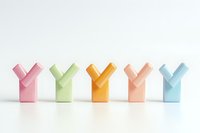 Colorful pastel Y-shaped geometric figures arranged in row on white background, minimalist composition for modern design and business presentations.