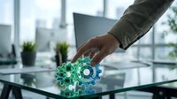 Business professional interacting with holographic gear mechanism interface on glass table in modern office environment for technology innovation concepts.