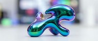 Iridescent liquid metal sculpture with flowing curves and reflective surfaces, displaying vibrant turquoise and purple hues. Suitable for modern art, design, and technology concepts.