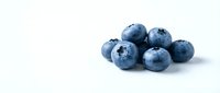 Fresh ripe blueberries grouped together on a white background, showcasing vibrant blue color and natural texture for food and health concepts.