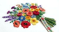 Colorful hand embroidered wildflower bouquet with poppies, daisies and lavender on white fabric. Traditional needlework craft for home decor and textile art.