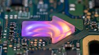 Futuristic holographic display emerging from computer circuit board with purple and pink glowing interface technology concept for digital innovation presentations.
