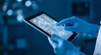 Medical professional using digital tablet with data analytics in modern healthcare facility for patient management and clinical research.