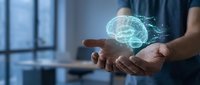 Man holding glowing brain hologram in palm, representing artificial intelligence, neural networks, and digital innovation technology for business solutions.