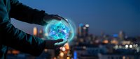 Businessman holding glowing digital earth globe with network connections against blurred city skyline at night representing global business technology.