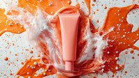 Coral cosmetic tube with dynamic water splash and orange paint explosion on light background, showcasing skincare product packaging for beauty advertising.