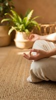 Woman in white clothing practicing meditation and mindfulness on natural fiber mat with potted plants, promoting wellness, relaxation and yoga lifestyle.