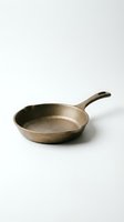 Empty cast iron skillet with long handle on white background, suitable for cooking, kitchenware product photography, and culinary content.