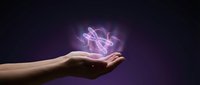 Human hand holding glowing purple energy light effect with magical flowing streams against dark background for fantasy and supernatural concepts.