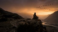 Person meditating on mountain cliff at sunset with birds flying overhead in peaceful valley landscape for wellness and mindfulness concepts.