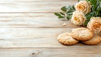 Fresh baked homemade cookies with peach roses on rustic wooden background, copy space for text, romantic food styling composition.