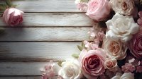 Delicate pink and white roses arranged on rustic wooden planks, creating romantic vintage composition for wedding or celebration backdrop.
