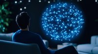 Man looking at glowing blue digital network sphere visualization in dark room, representing global connectivity and data analysis.