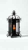 Ornate black metal lantern with lit orange candle inside, featuring decorative scrollwork and glass panels, isolated on white background for home decor and lighting design.