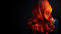 Vibrant copper red wavy hair flowing against dark background, dramatic lighting highlights glossy curls and movement in feminine hairstyle.