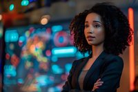 Young African American businesswoman with curly hair standing confidently with arms crossed against colorful urban night lights background.