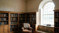 Cozy home library with wooden bookshelves, leather armchair and arched window creating peaceful reading nook for relaxation and study.