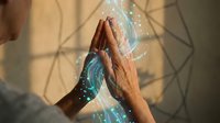 Young professional woman touching holographic digital interface with glowing blue circular patterns and data visualization in modern office environment.