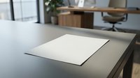 Blank white paper document on modern office desk with blurred workspace background for business presentations and corporate communications.