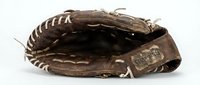 Vintage brown leather baseball glove with worn texture and white stitching details isolated on white background for sports design projects.