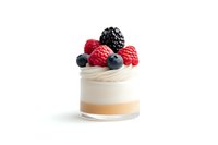 Layered dessert with fresh berries in glass jar featuring raspberry, blackberry and blueberry toppings on white cream mousse, isolated on white background.