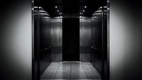 Modern elevator interior with stainless steel walls and LED lighting creating sleek architectural space for commercial building design projects.