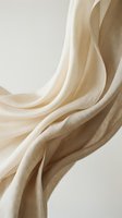Flowing cream silk fabric with elegant drapes and soft curves creating luxurious textile waves against neutral background for fashion design projects.