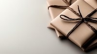 Minimalist gift boxes wrapped in neutral beige craft paper with black twine bow on light background, corner composition for holiday and celebration design.