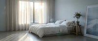Serene bedroom interior with unmade bed, soft natural light streaming through sheer curtains, wooden nightstand with plant, and minimalist decor for home design projects.