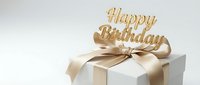 White gift box with golden satin ribbon bow and Happy Birthday golden sign on top, elegant celebration present on light background.