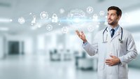 Young male doctor in white coat with stethoscope presenting digital healthcare technology icons in modern hospital setting for medical innovation.