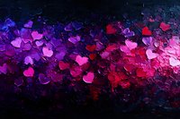 Vibrant heart shapes in pink, red and purple colors scattered on dark background create romantic atmosphere for Valentine's day cards and love themes.