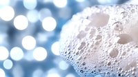 Detailed moon surface with craters against soft bokeh lights background for astronomy education and space exploration content.