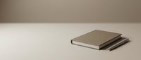 Stacked closed notebooks with neutral covers on white surface, minimalist workspace setup for business, education, and creative projects.