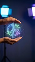 Hands protecting holographic renewable energy symbols with wind turbine and sun icons floating between palms against dark blue background with bokeh lights.