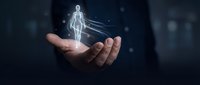 Businessman holding glowing digital human body hologram in palm, representing healthcare technology, medical innovation, and futuristic digital wellness solutions.